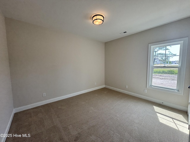 carpeted empty room with baseboards and visible vents