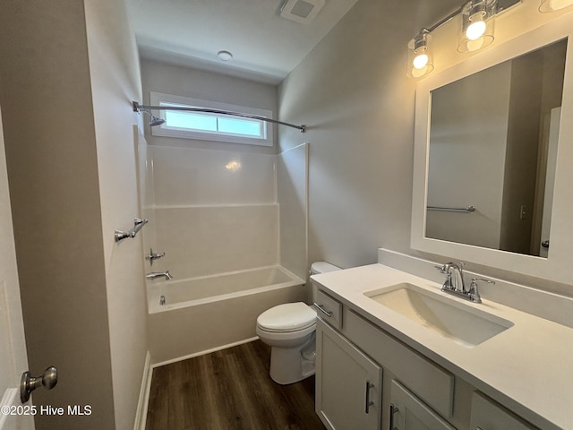 bathroom with vanity, toilet, shower / bath combination, wood finished floors, and visible vents