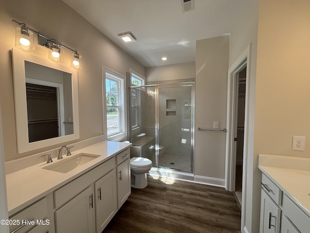 bathroom featuring vanity, toilet, and a stall shower