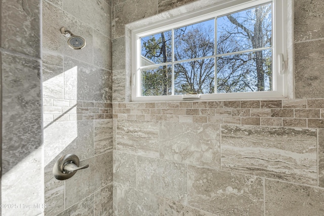 full bath with a tile shower