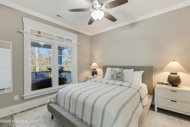bedroom featuring baseboards, ornamental molding, visible vents, and wood finished floors