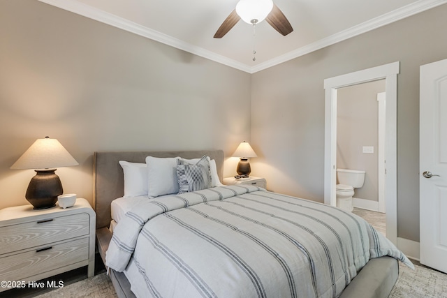 bedroom featuring baseboards, ensuite bath, ceiling fan, and crown molding