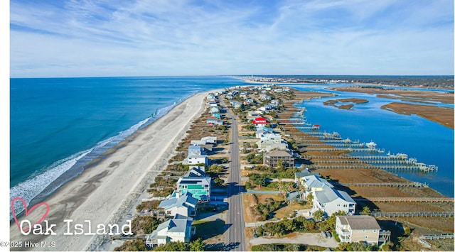 drone / aerial view with a beach view and a water view