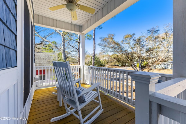 wooden deck featuring ceiling fan