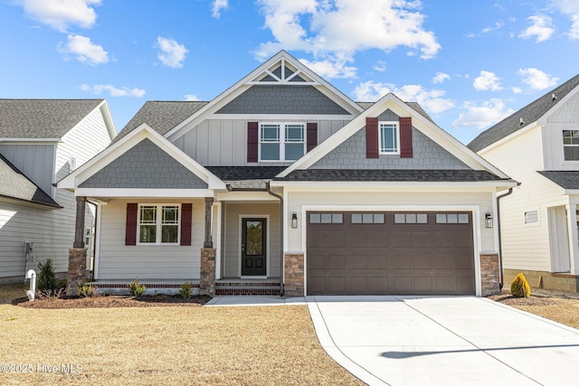 craftsman-style house featuring board and batten siding, driveway, a shingled roof, and an attached garage