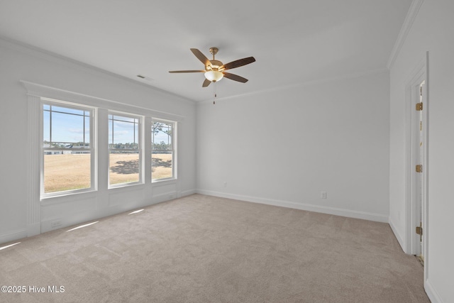 unfurnished room featuring a ceiling fan, light carpet, crown molding, and visible vents