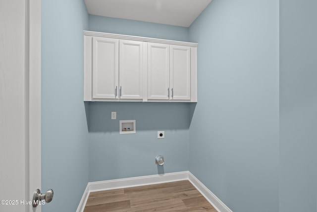 washroom with cabinet space, baseboards, wood finished floors, hookup for an electric dryer, and washer hookup