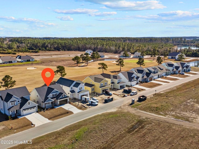 bird's eye view featuring a forest view and a residential view