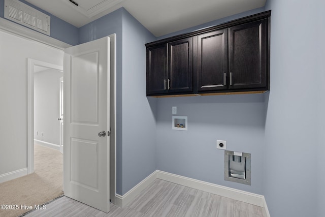 laundry room with hookup for an electric dryer, washer hookup, visible vents, baseboards, and cabinet space