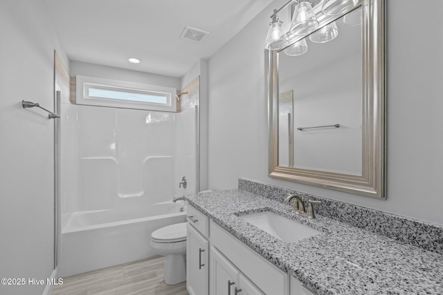 bathroom with shower / tub combination, toilet, wood finished floors, vanity, and visible vents