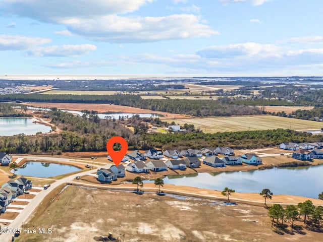 bird's eye view featuring a water view and a residential view