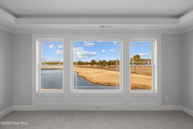 interior space with baseboards, visible vents, carpet flooring, and ornamental molding