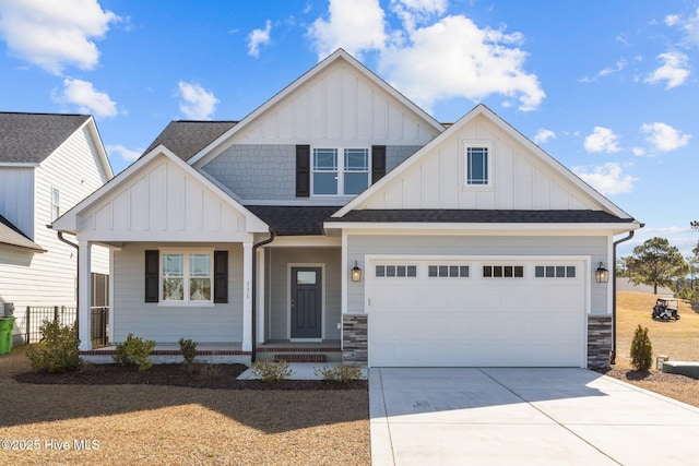 view of front facade featuring roof with shingles, board and batten siding, a garage, stone siding, and driveway