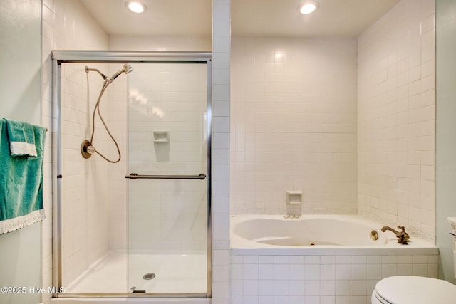 bathroom featuring toilet and independent shower and bath