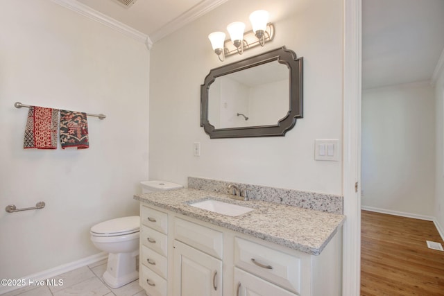 bathroom with vanity, crown molding, toilet, and hardwood / wood-style flooring