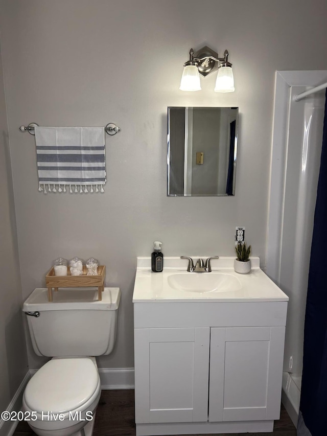 613 Sexton Ave, Zebulon, NC 27597 - bathroom with baseboards, toilet, and vanity