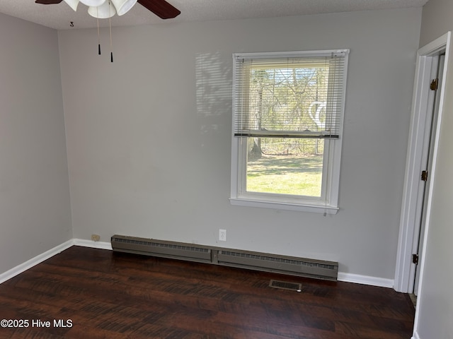 613 Sexton Ave, Zebulon, NC 27597 - spare room featuring a textured ceiling, baseboards, wood finished floors, a ceiling fan, and a baseboard heating unit