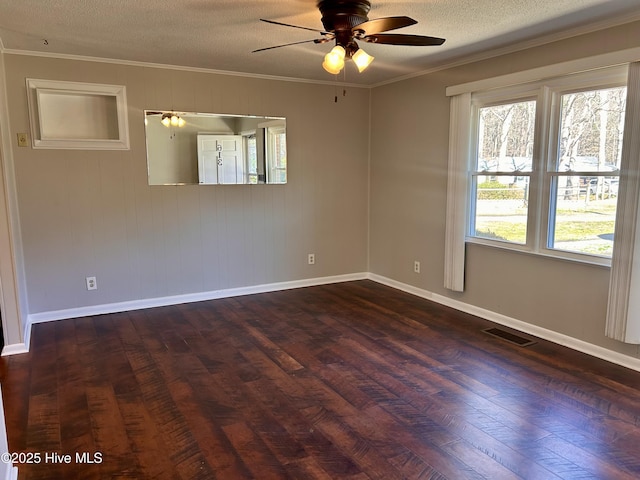 unfurnished room with ornamental molding, dark wood-type flooring, ceiling fan, and a textured ceiling