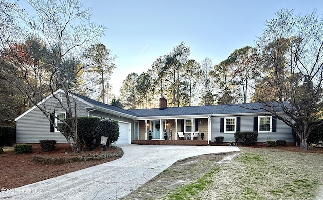 ranch-style house featuring a garage and a porch