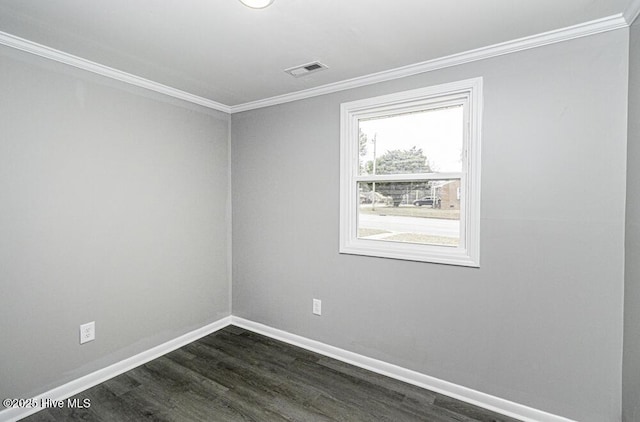 empty room featuring ornamental molding and dark hardwood / wood-style flooring