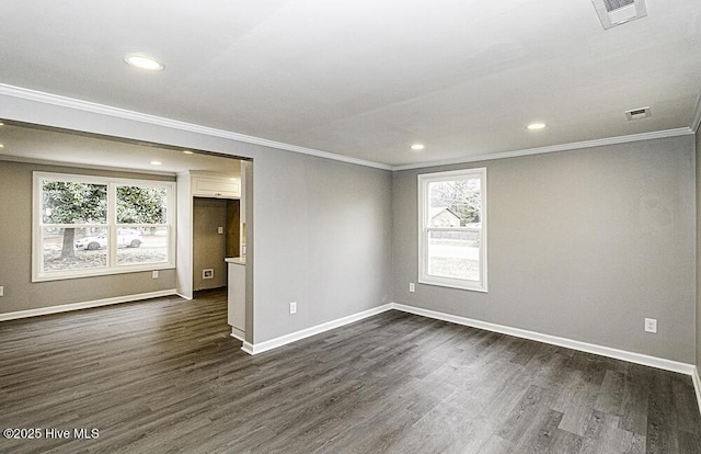 spare room featuring ornamental molding and dark wood-type flooring