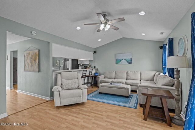 1810 Paulette Rd, Morehead City, NC 28557 - living area with light wood finished floors, ceiling fan, lofted ceiling, baseboards, and recessed lighting