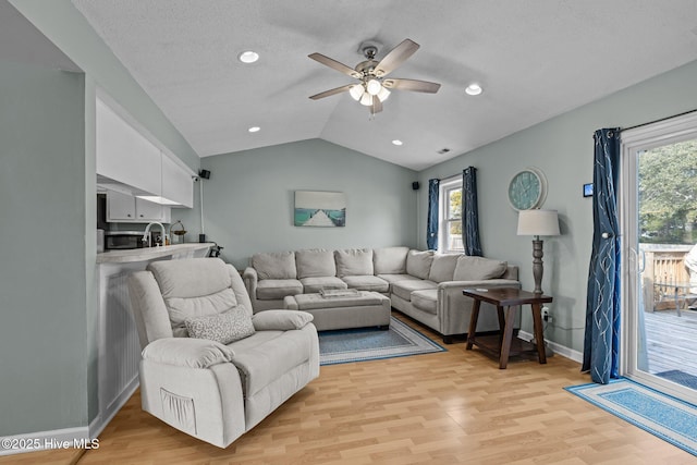 1810 Paulette Rd, Morehead City, NC 28557 - living area with lofted ceiling, light wood-style flooring, ceiling fan, plenty of natural light, and baseboards