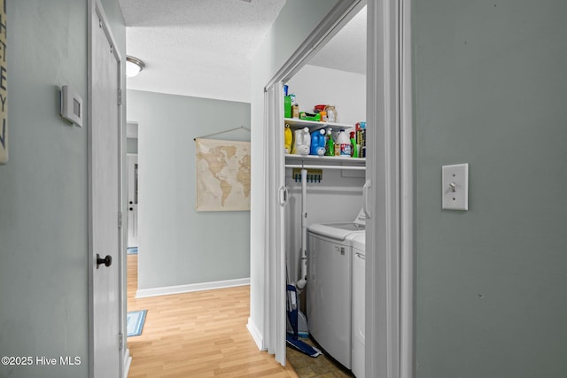 1810 Paulette Rd, Morehead City, NC 28557 - washroom featuring washing machine and clothes dryer, light wood-style flooring, a textured ceiling, and baseboards