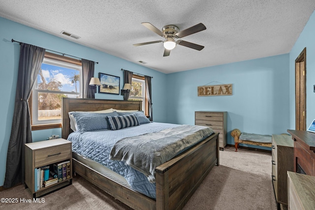 1810 Paulette Rd, Morehead City, NC 28557 - bedroom with carpet flooring, a textured ceiling, and a ceiling fan