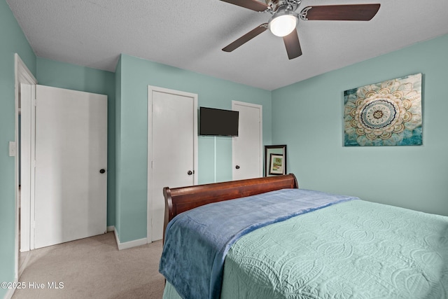 1810 Paulette Rd, Morehead City, NC 28557 - bedroom with light carpet, baseboards, ceiling fan, and a closet