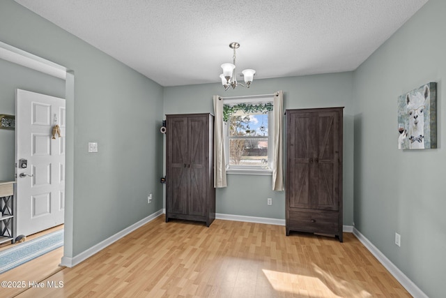 1810 Paulette Rd, Morehead City, NC 28557 - entrance foyer with wood finished floors, a chandelier, baseboards, and a textured ceiling