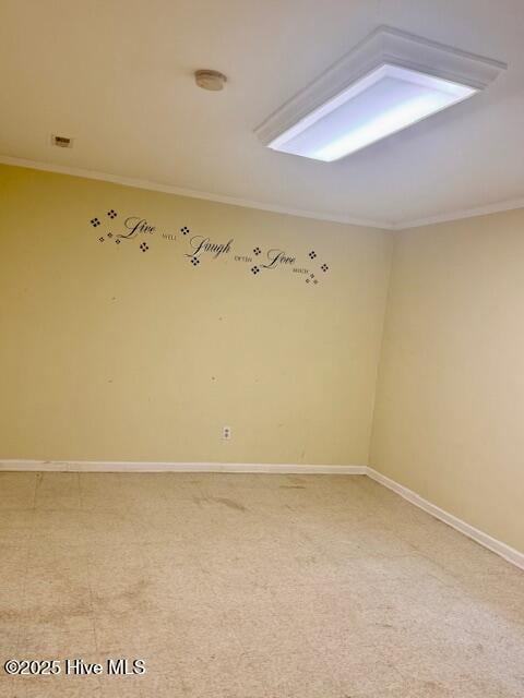 carpeted empty room featuring ornamental molding