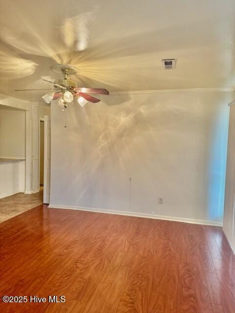 spare room featuring crown molding, ceiling fan, and hardwood / wood-style floors