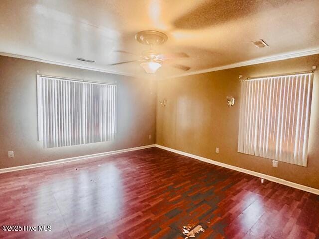 unfurnished room with ceiling fan, ornamental molding, and dark hardwood / wood-style flooring