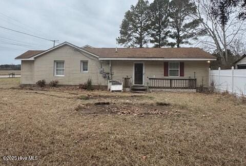 rear view of house with a yard