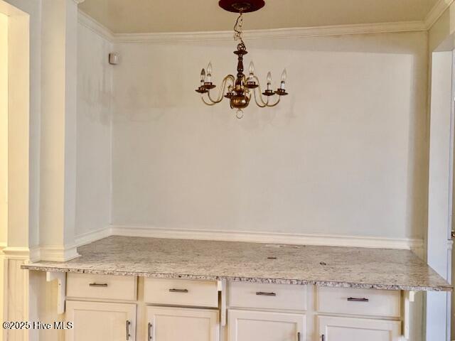 room details featuring ornamental molding and a chandelier