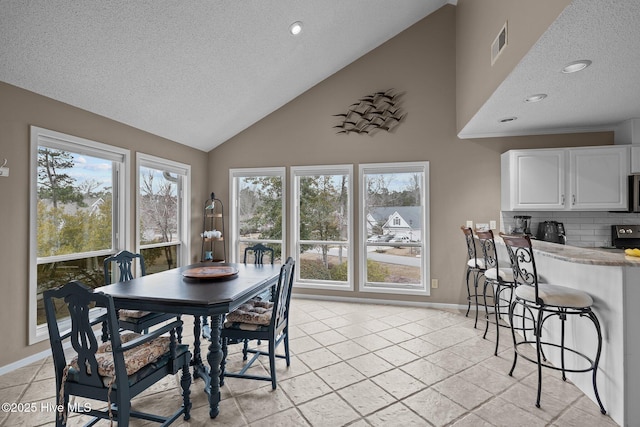 806 Lord Granville Dr, Morehead City, NC 28557 - dining room featuring a textured ceiling, high vaulted ceiling, baseboards, and recessed lighting