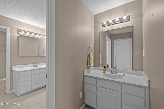 806 Lord Granville Dr, Morehead City, NC 28557 - bathroom with a textured ceiling, two vanities, and baseboards