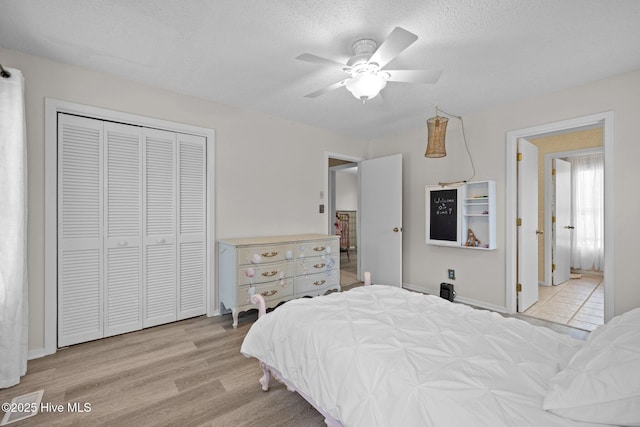 806 Lord Granville Dr, Morehead City, NC 28557 - bedroom featuring wood finished floors, a closet, a textured ceiling, ceiling fan, and baseboards