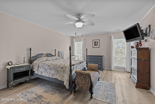 806 Lord Granville Dr, Morehead City, NC 28557 - bedroom featuring multiple windows, light wood-style flooring, baseboards, ceiling fan, and crown molding