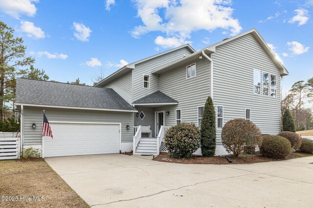 806 Lord Granville Dr, Morehead City, NC 28557 - traditional home with a garage, driveway, and a shingled roof