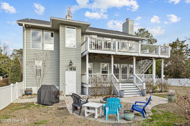 806 Lord Granville Dr, Morehead City, NC 28557 - back of house with stairs, a fenced backyard, a chimney, and a wooden deck
