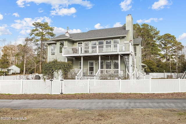 806 Lord Granville Dr, Morehead City, NC 28557 - back of property with a gate, a fenced front yard, a deck, a chimney, and a porch