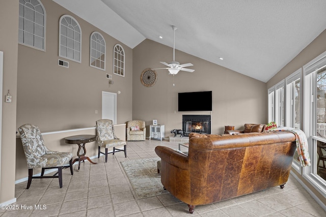 806 Lord Granville Dr, Morehead City, NC 28557 - living area featuring a glass covered fireplace, light tile patterned floors, high vaulted ceiling, and a ceiling fan
