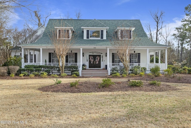 view of front of property with covered porch and a front lawn