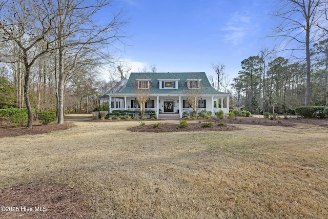 cape cod-style house featuring covered porch and a front lawn