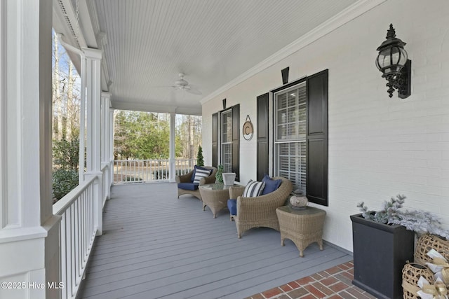 wooden deck with ceiling fan and a porch