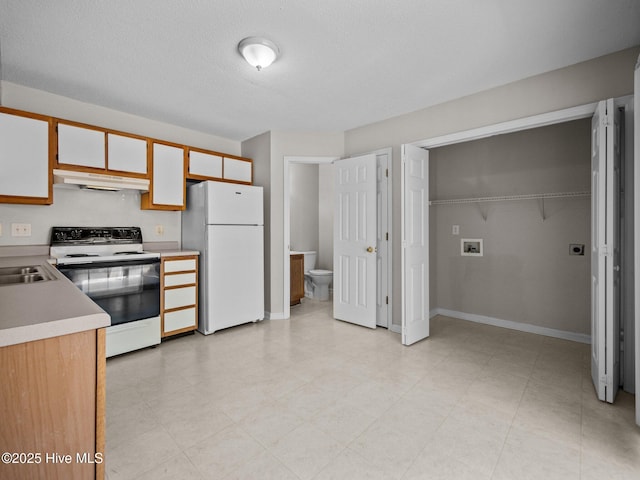 kitchen featuring white cabinetry, sink, white appliances, and a textured ceiling