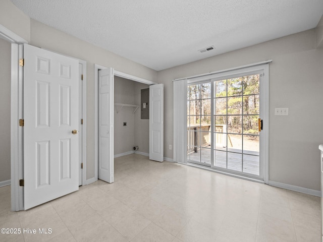 unfurnished room featuring a textured ceiling