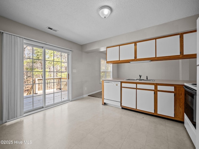 kitchen with white cabinetry, sink, electric range, white dishwasher, and a textured ceiling